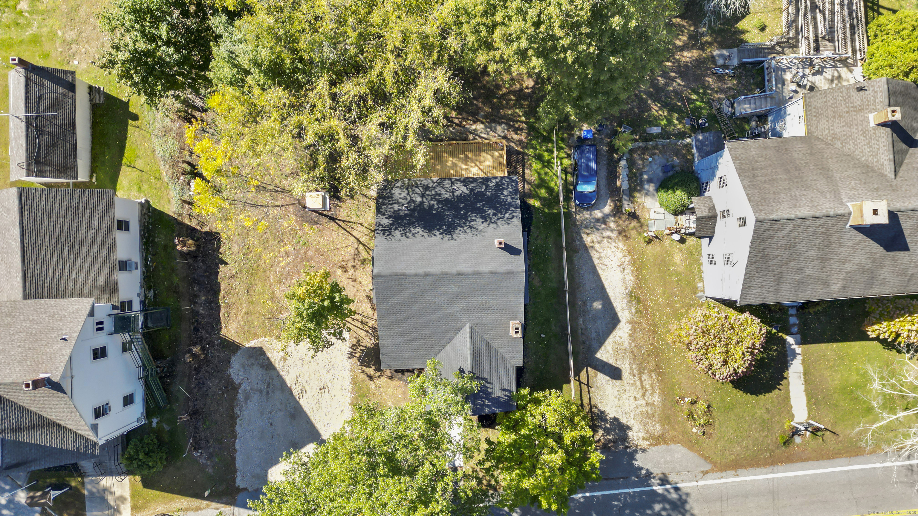 an aerial view of a residential houses with yard