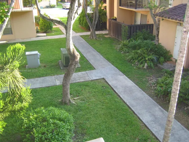 a backyard of a house with lots of green space and fountain