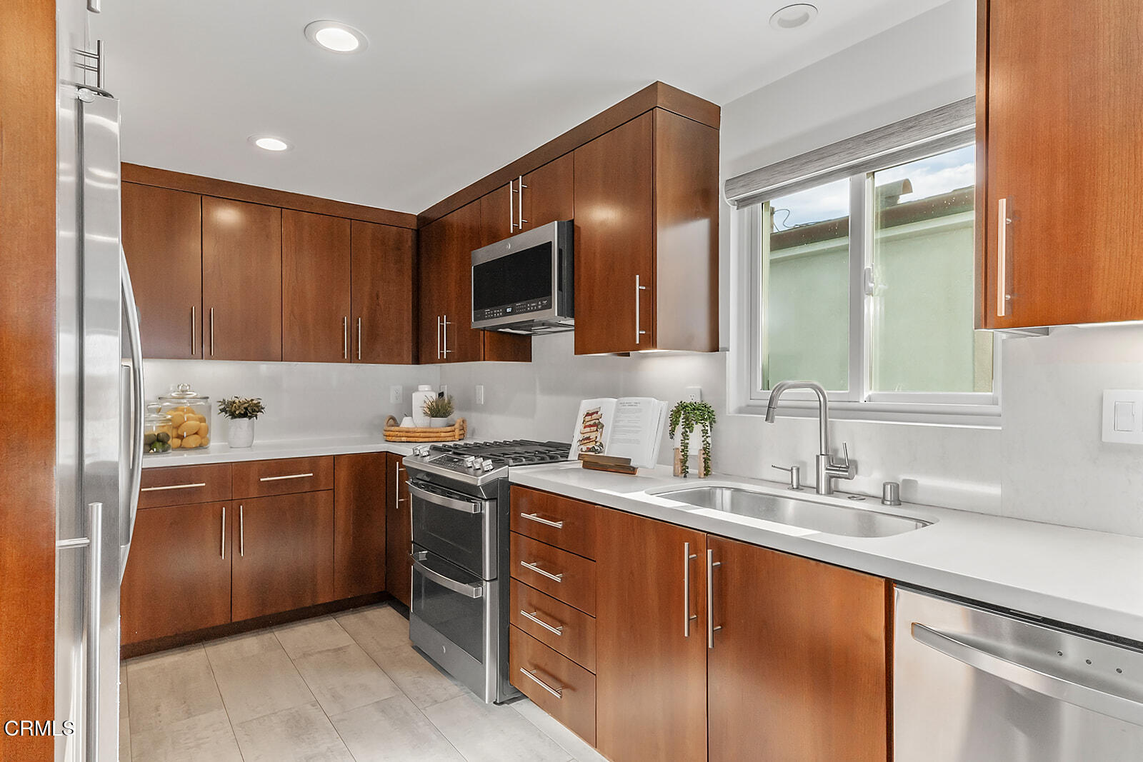 92 B Surfside Avenue Surfside, CA 90743 - Photo 19 of 47 a kitchen with stainless steel appliances granite countertop a sink stove and refrigerator