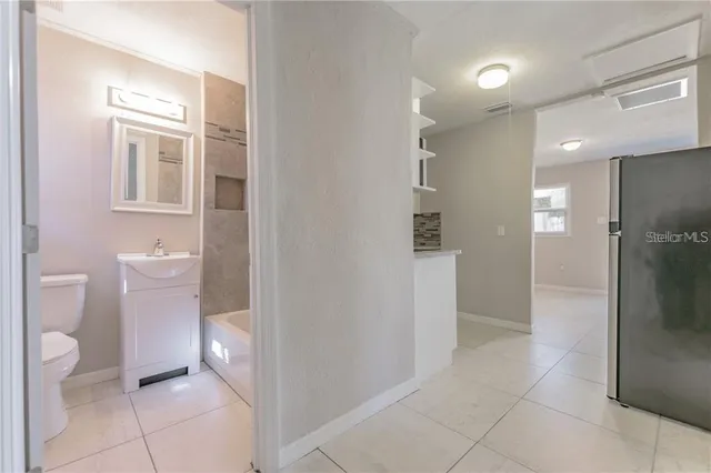 a bathroom with a toilet sink and shower