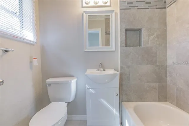 a bathroom with a toilet a sink and bathtub