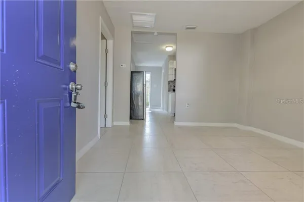 a view of a hallway with wooden shelves
