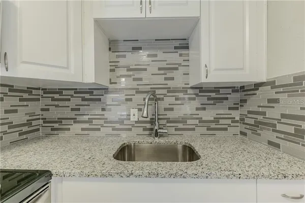 a kitchen with a sink and cabinets