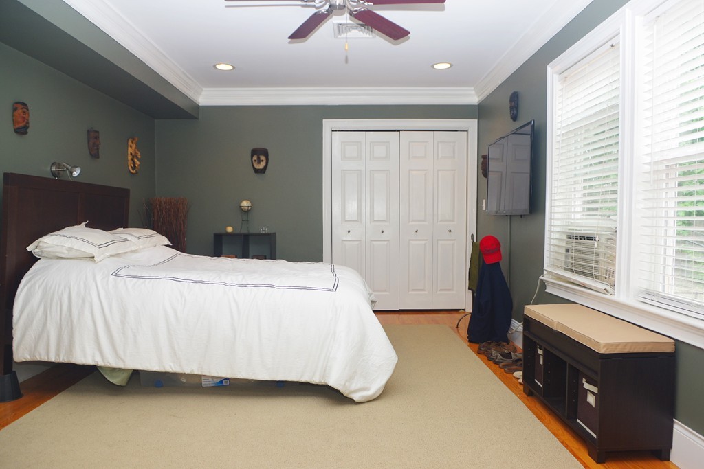 39 Juliette Street, Unit 3 Boston, MA 02122 - Photo 13 of 20 a bedroom with a bed and a chandelier