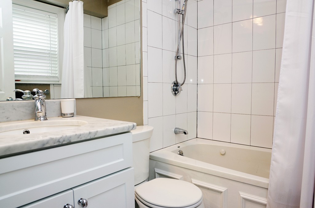 39 Juliette Street, Unit 3 Boston, MA 02122 - Photo 16 of 20 a bathroom with a granite countertop sink toilet and bathtub