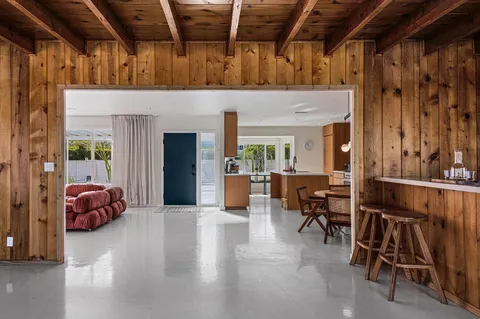 a view of a livingroom with furniture and a garage