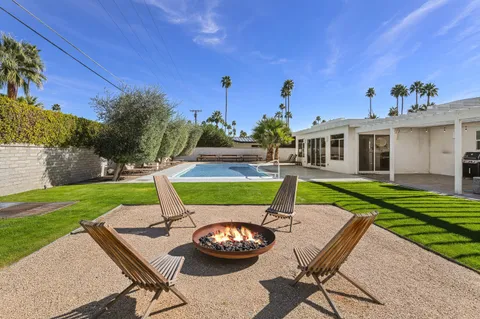a view of a backyard with plants and patio