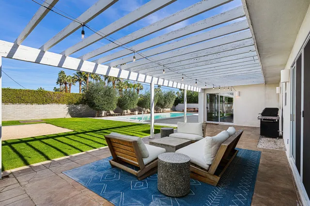 a sitting area with furniture and garden view