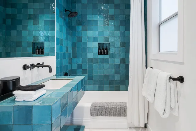 a bathroom with a tub sink and shower