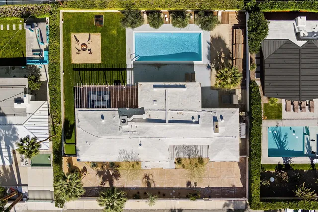 an aerial view of residential houses with outdoor space