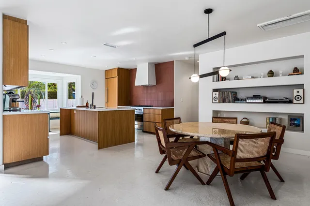 a view of a dining room with furniture and chandelier