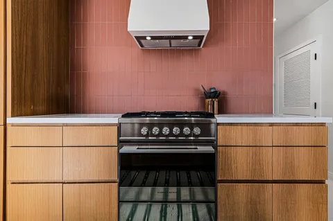 a kitchen with a refrigerator and a stove