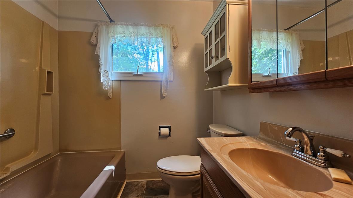 2529 Ringhoffer Road Hellertown, PA 18055 - Photo 11 of 33 A well-maintained bathroom with a warm-toned tub, complete with a window for natural light.