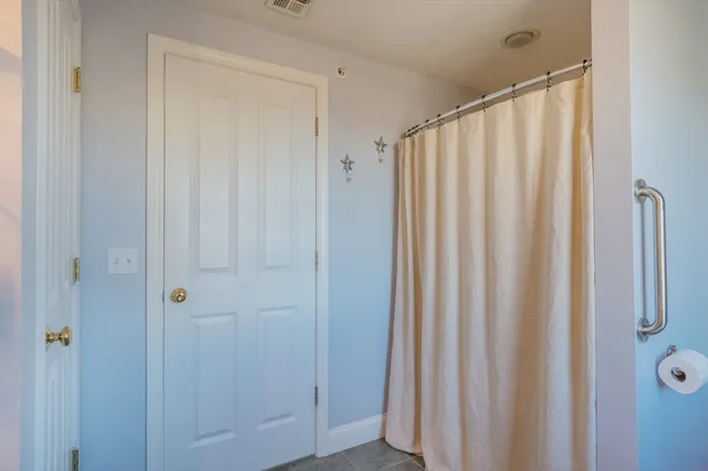 a view of a bathroom with a shower curtain