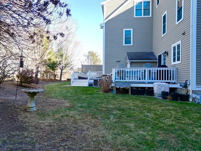a view of a house with a yard and deck