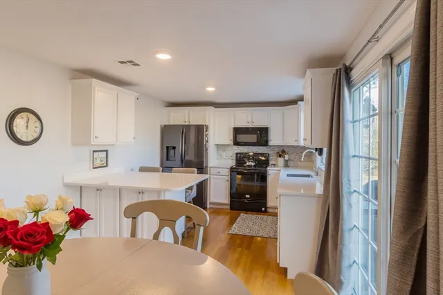 a kitchen with stainless steel appliances a refrigerator sink stove microwave and cabinets