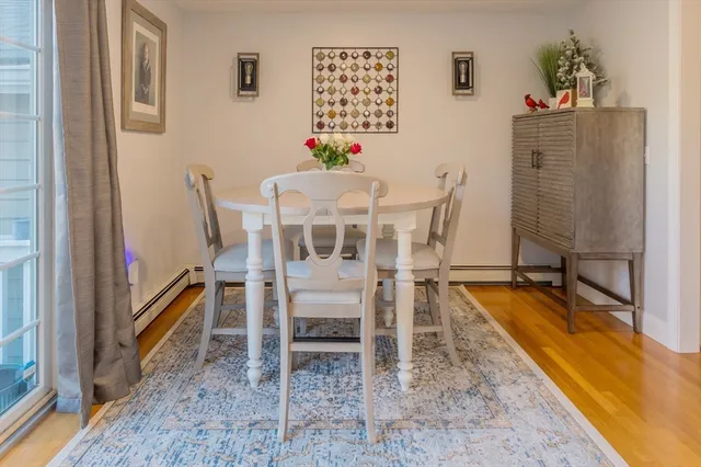a dining room with furniture and a floor to ceiling window
