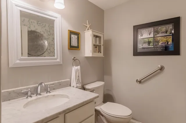 a bathroom with a toilet a sink and mirror