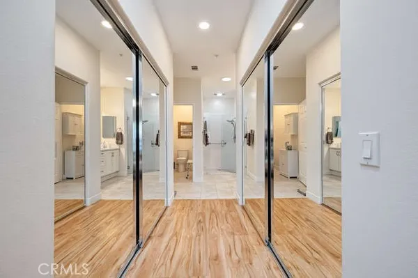a bathroom with a glass door shower and a mirror