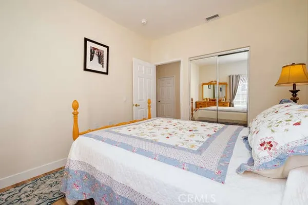 a bedroom with a bed and a dresser in it