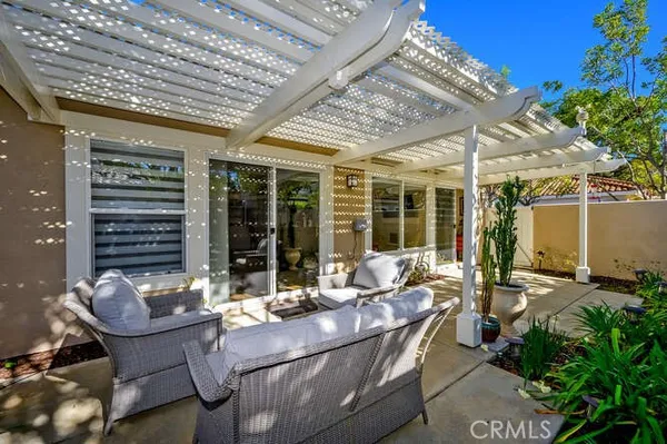 a building outdoor space with patio furniture and potted plants
