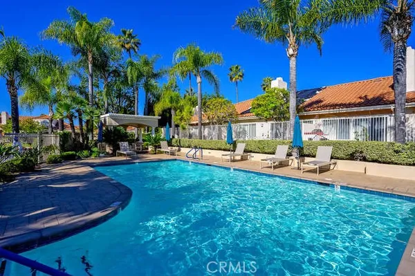 a view of a house with swimming pool and sitting area
