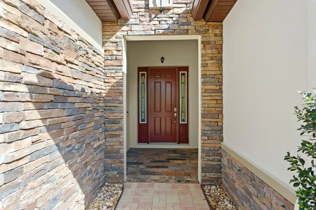 a living room with furniture and a view of kitchen