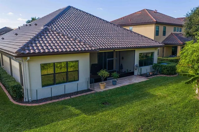 a view of a swimming pool with a patio and a garden