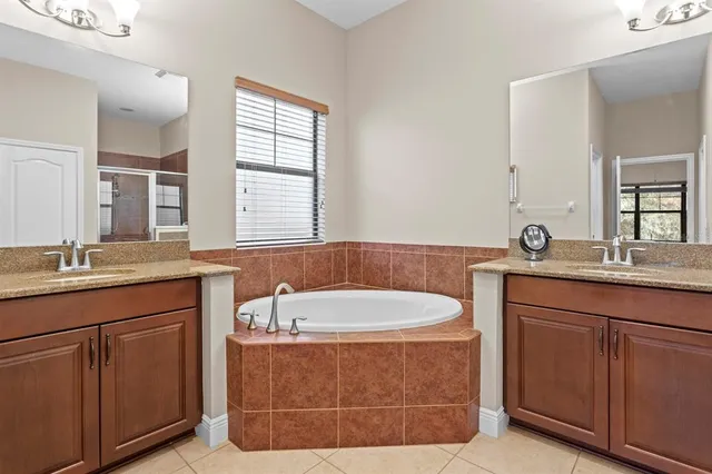 an aerial view of a house with garden space and swimming pool