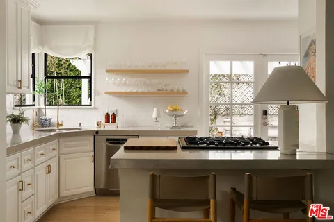 a kitchen with a sink cabinets and window