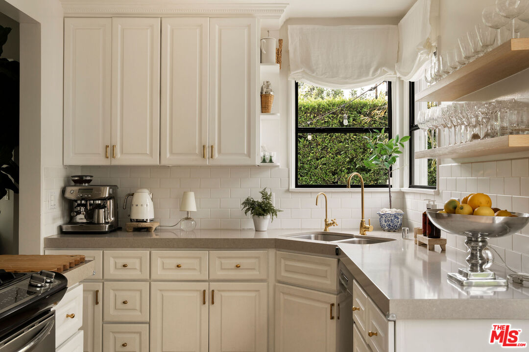 4080 Alla Road Los Angeles, CA 90066 - Photo 13 of 57 a kitchen with stainless steel appliances a sink a stove and a window