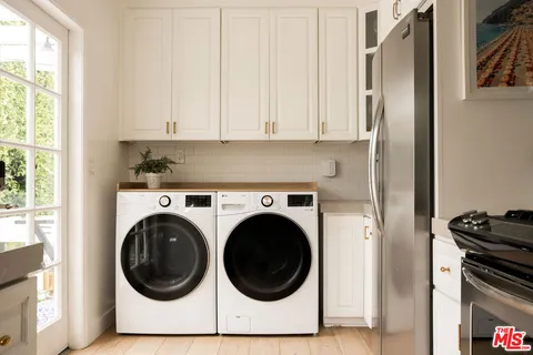 a utility room with sink dryer and washer
