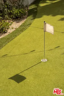 a view of swimming pool with seating area and trees in the background