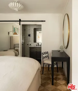 a bedroom with furniture and a window