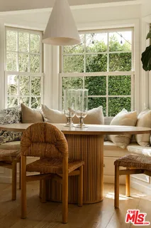 a living room with furniture a flat screen tv and kitchen view