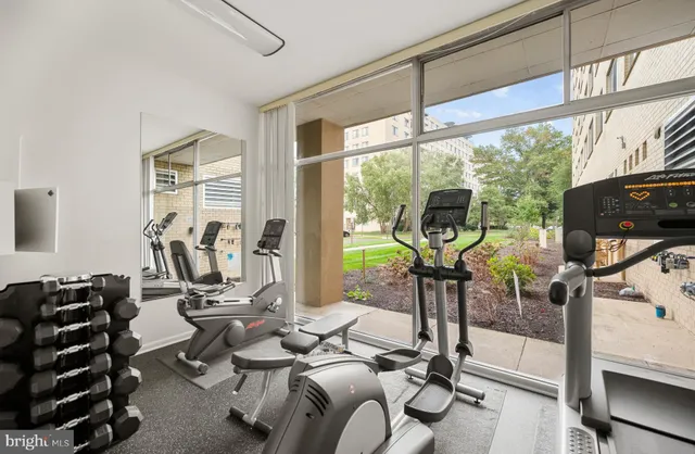 a room with gym equipment and a large window