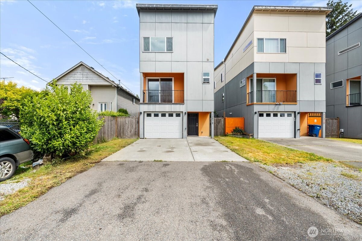 12418 2nd Place Southwest Burien, WA 98146 - Photo 36 of 39 a house with parking space and a car parked in front of it