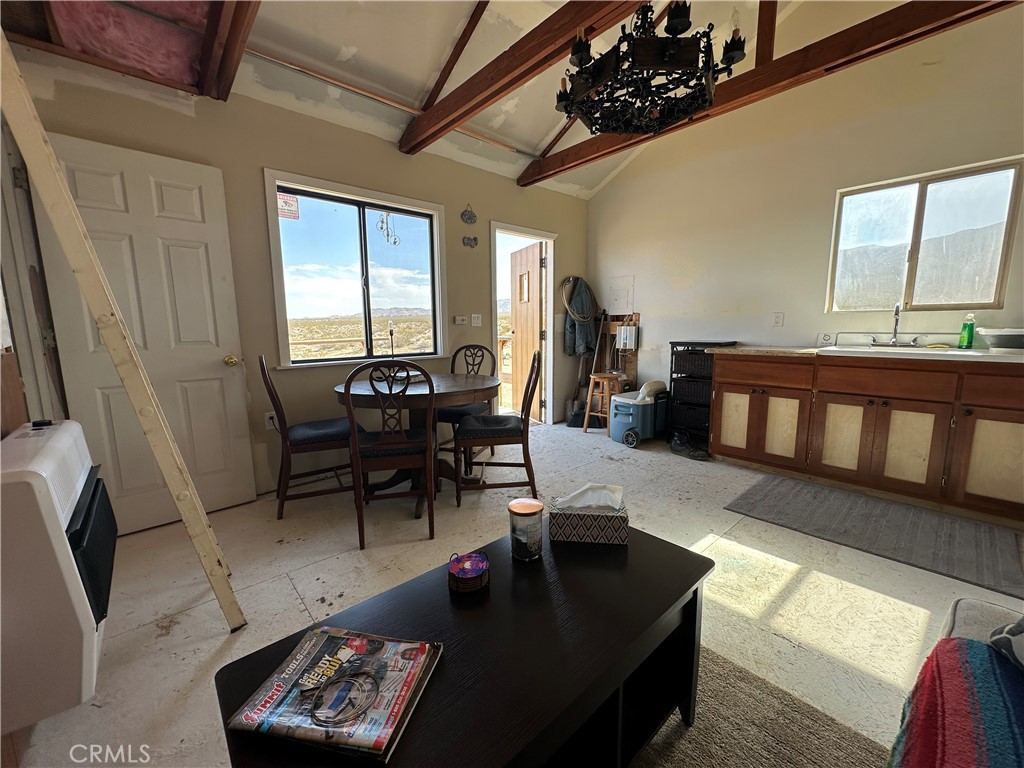 777 Walker Road Johnson Valley, CA 92285 - Photo 11 of 21 a living room with furniture and a dining table with wooden floor