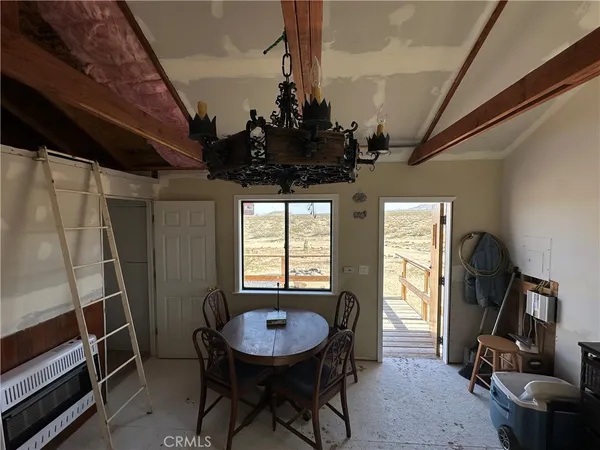 a view of a room with furniture and window