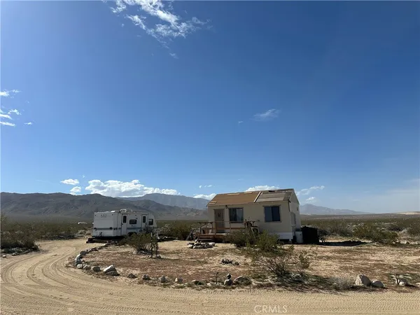 a view of a livingroom with furniture and mountain view