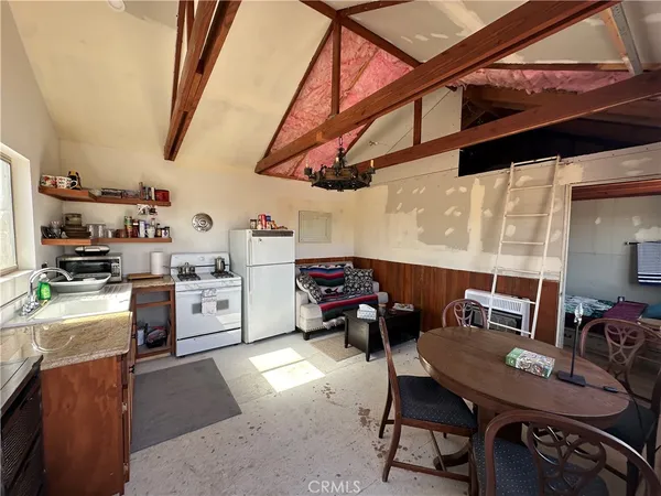 a living room with lots of furniture and clutter