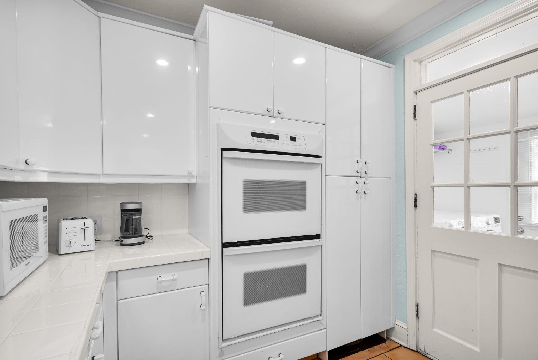 519 28th Street, Unit MAIN HOUSE West Palm Beach, FL 33407 - Photo 26 of 67 a kitchen with granite countertop white cabinets and white appliances