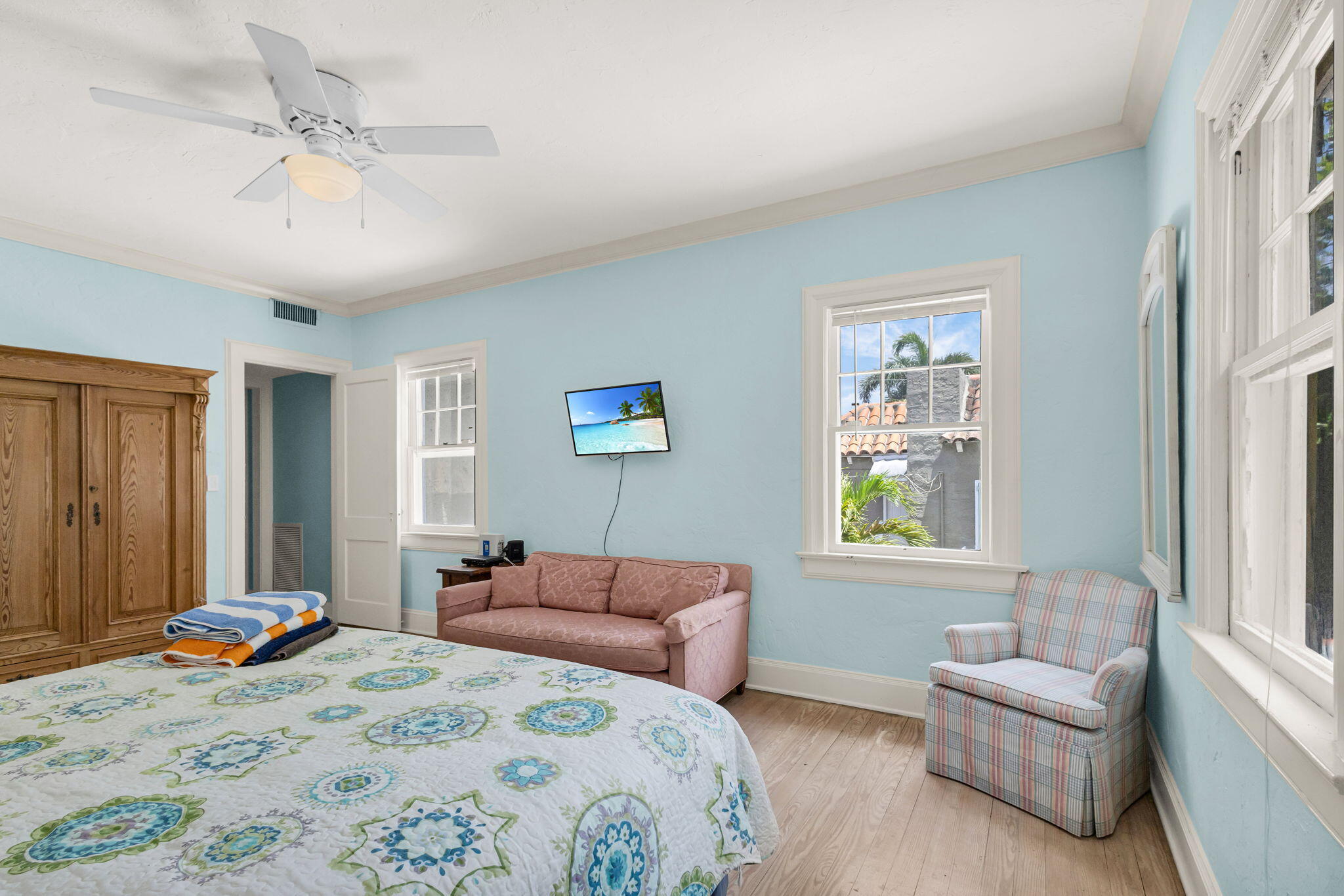 519 28th Street, Unit MAIN HOUSE West Palm Beach, FL 33407 - Photo 42 of 67 a bedroom with a bed couches and a flat tv screen