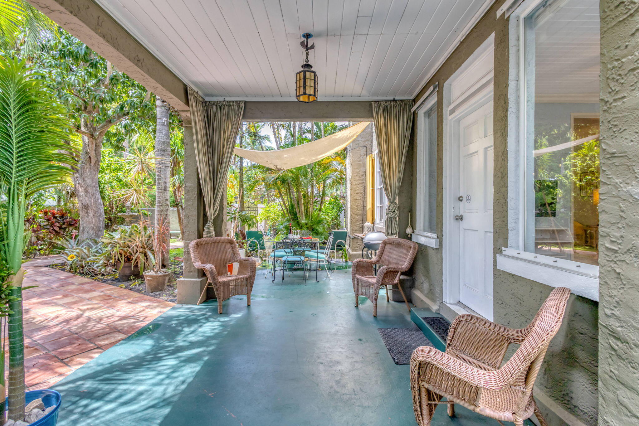 519 28th Street, Unit MAIN HOUSE West Palm Beach, FL 33407 - Photo 52 of 67 a living room with patio furniture and floor to ceiling windows