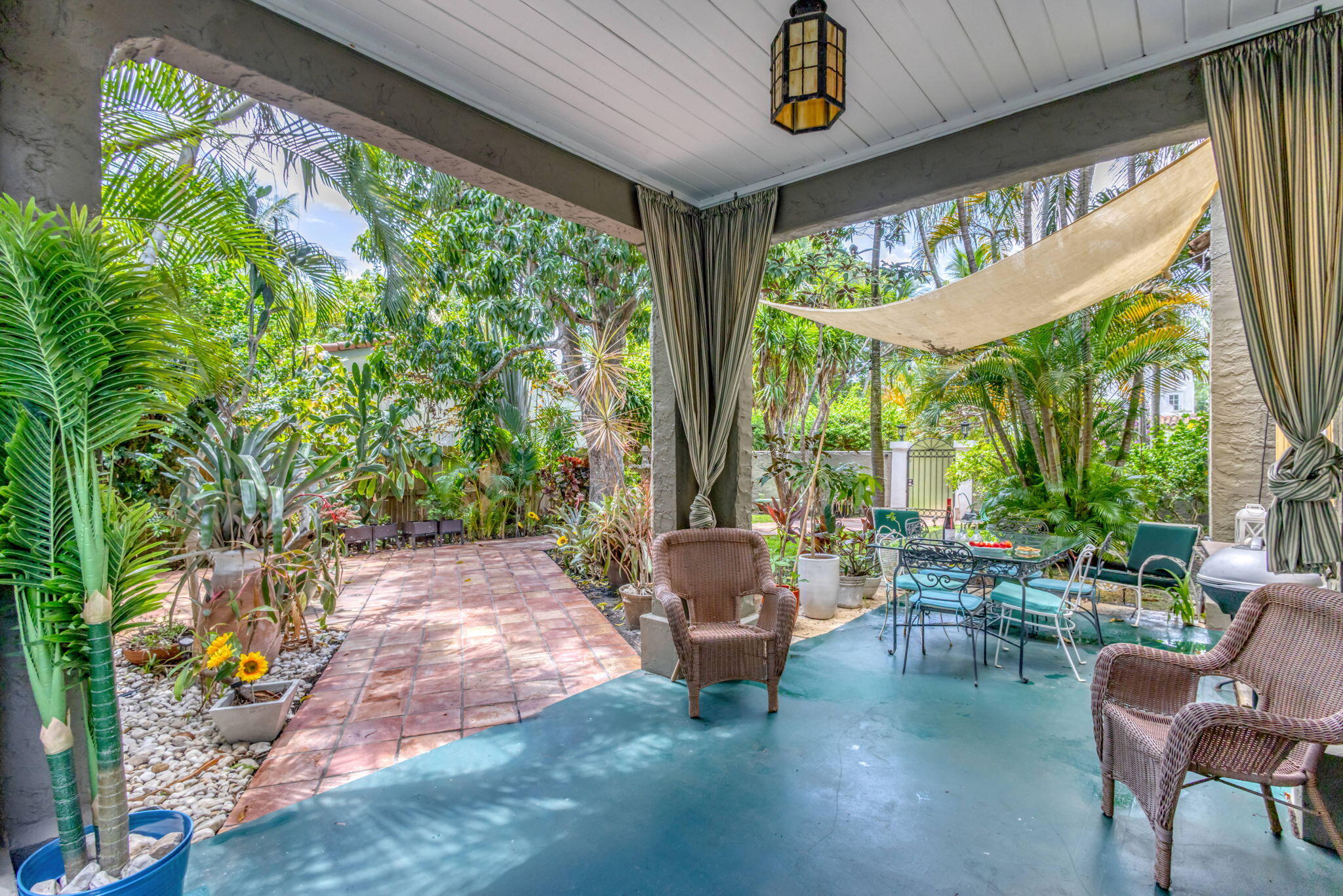 519 28th Street, Unit MAIN HOUSE West Palm Beach, FL 33407 - Photo 53 of 67 a living room with patio furniture and a floor to ceiling window