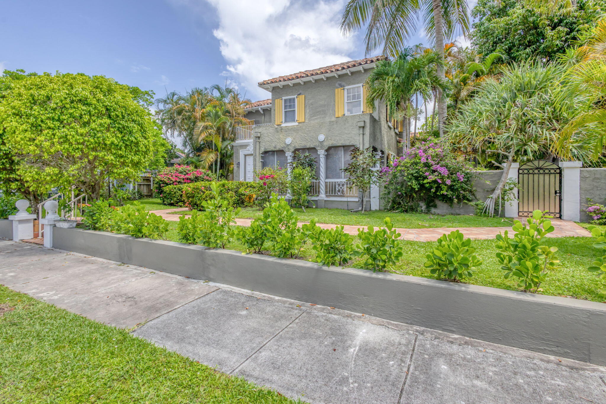 519 28th Street, Unit MAIN HOUSE West Palm Beach, FL 33407 - Photo 64 of 67 a front view of a house with a yard and potted plants