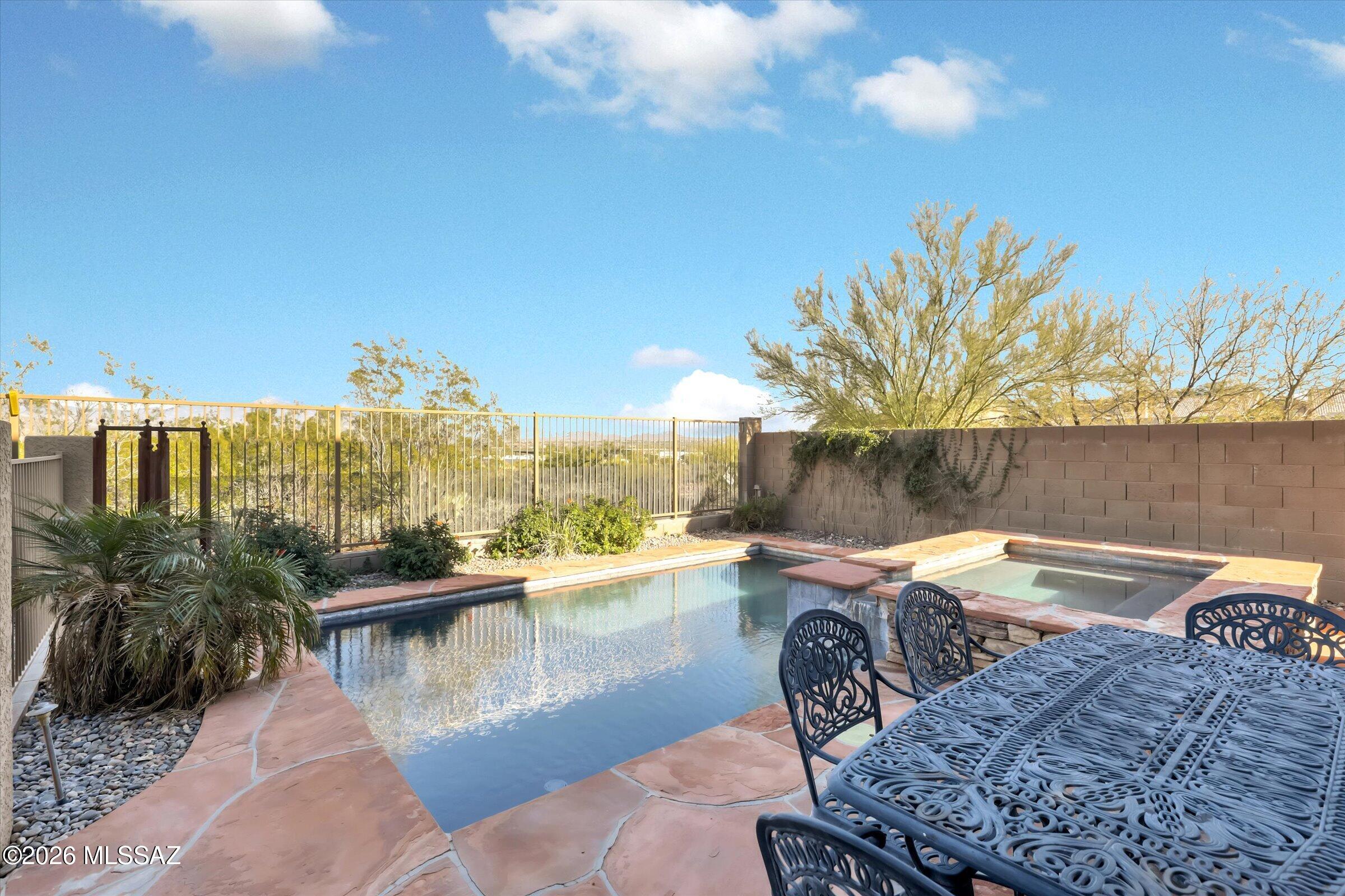 6095 South Jakemp Trail Tucson, AZ 85747 - Photo 46 of 52 a view of a swimming pool and lounge chair