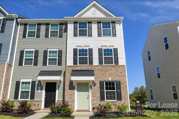 a front view of a house with plants