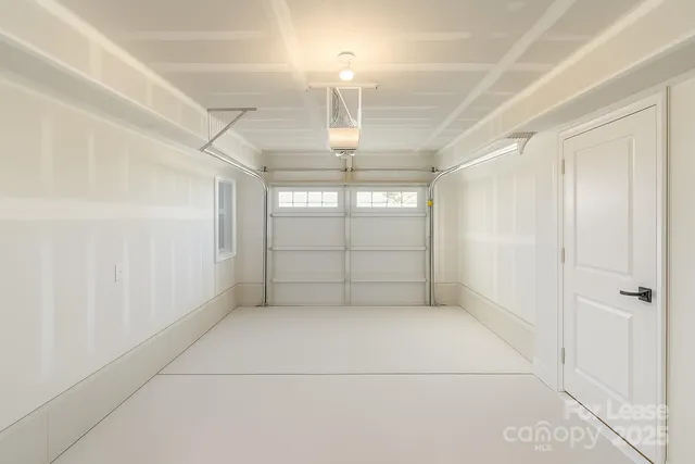 an empty room with windows and entrance