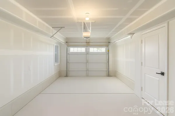 an empty room with windows and entrance